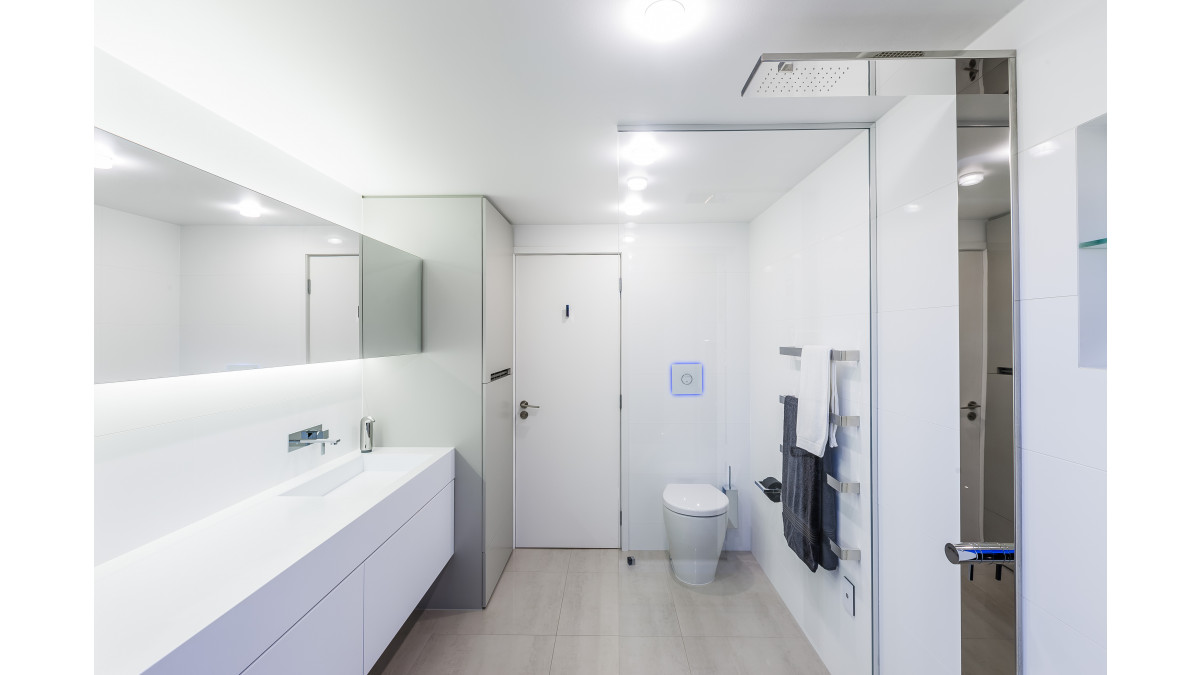 Vanity top, integrated sink and cabinet doors in Corian Architects White (now superseded by Corian Designer White). Design by Celia Visser. National Kitchen and Bathroom Association award-winning bathroom (2014).