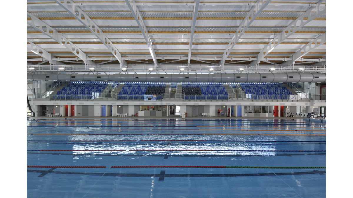 National Aquatic Pool in foreground with terrace seating.