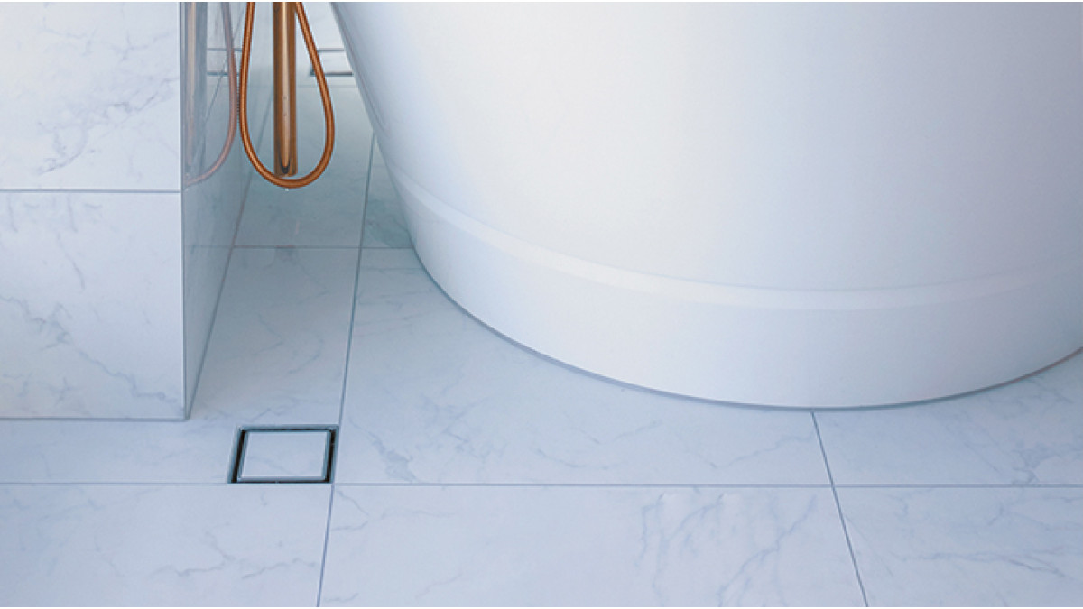 InvisiDrain tile insert drain grate next to bath floor overflow drain product slide