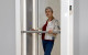 woman inside the Through floor lift Luma by Savaria