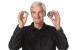 James Dyson with a motor from the Supersonic Hair Dryer and a conventional hair dryer motor