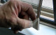 Close up of magnetic screen handle being lifted.