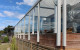 Edge Balustrade with slim interlinking top rail semiframeless in Silver Pearl
