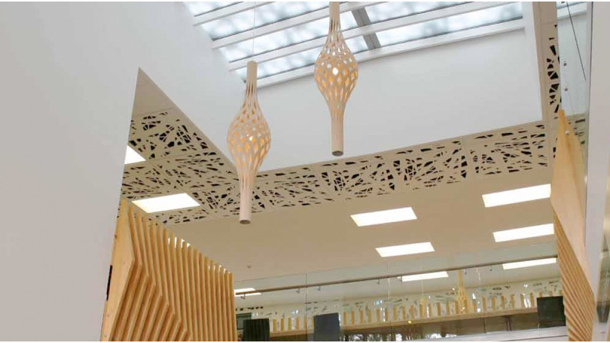 MAIN ENTRANCE OVERHEAD GLAZING: Overhead glazing above the main entrance was shaded by laser-cut metal panels in the recurring lattice motif. These were fixed to a secondary frame above the glass and acted as a solar screen. The glazing was Opalite laminate. The lattice motif can also be seen in some ceiling panels.