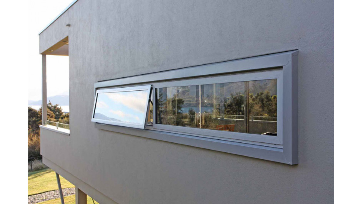 This window on a plaster-clad wall was set within a box frame for aesthetic reasons. Nick Hay applied a timber perimeter, overlayed building paper, then flashed it with folded steel in Sandstone Grey powder coat.