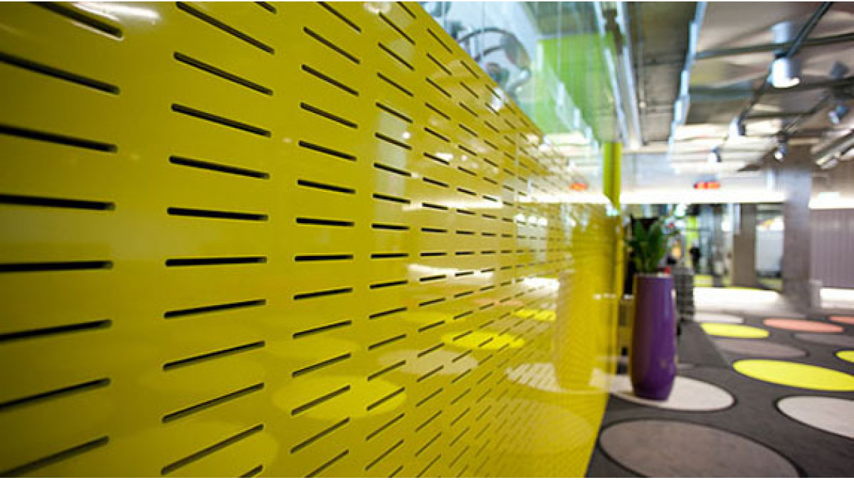 Atkar Au.diSlot was also used along the walls for further noise reduction. These perforated slot wall panels were sprayed in primary yellow and cool grey and had to navigate around difficult corners and encompass large public areas pulling the interior design together as a cohesive whole.