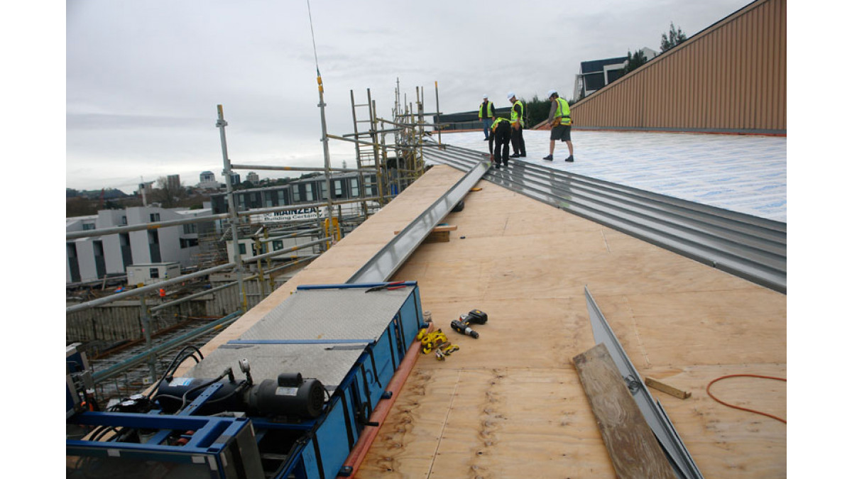 Creative sheet metal skills were used to peel back sections of the old cladding in order to fit customised flashings that provided the essential watertight connection.