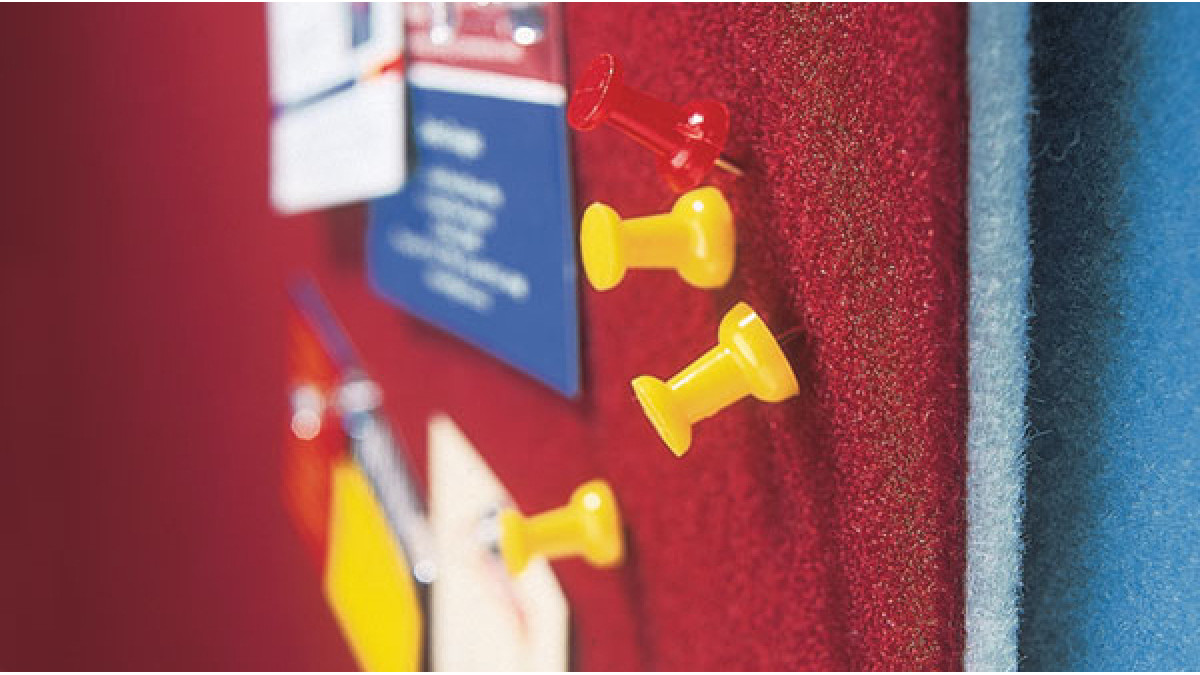 Composition wall covering features a pin board surface.