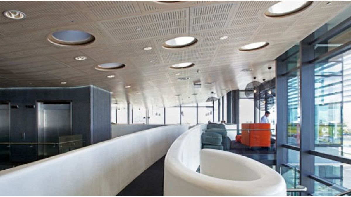 Slotted perforations were specified to achieve the open area and NRC values required for the acoustic treatment, with the perforations being stopped around penetrations and cut-outs to create features of the light columns.