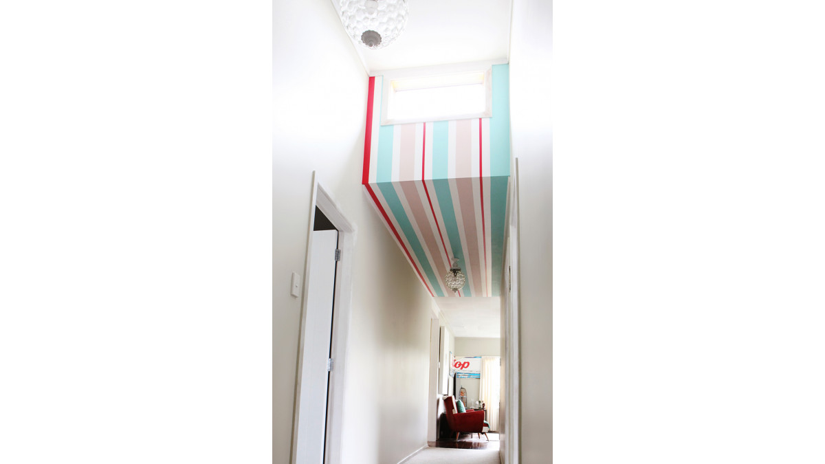  A retro tip top sign is in Resene Onepoto (blue), Resene Dust Storm (pink), Resene Knock Out (red) and Resene Alabaster (white), which is also the main wall and ceiling colour.<br />
 