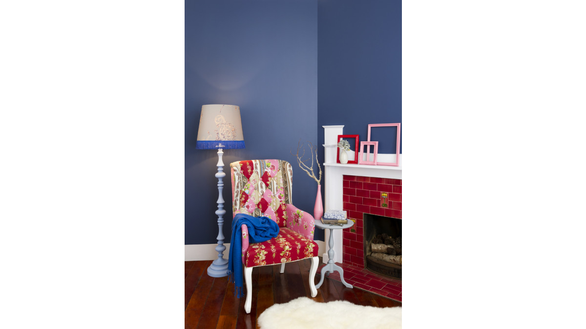  The walls are in Resene True Blue, the mantelpiece is Resene Half Breathless, the side table is Resene El Nino, the lamp base is Resene Zephyr and its shade is made from Bloomsbury House 25440 wallpaper. The book is covered in Bloomsbury House 25448 wallpaper. Frames are Resene Smashing and Resene Glamour Puss, the bottle is Resene Glamour Puss. Protect timber flooring with Resene Qristal ClearFloor.