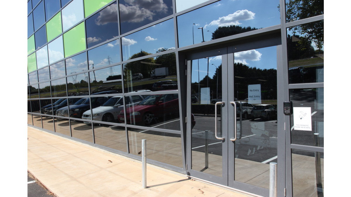 The 5º lean of the Flushglaze facade is highlighted by the APL Magnum hinged doors inset into the window system.