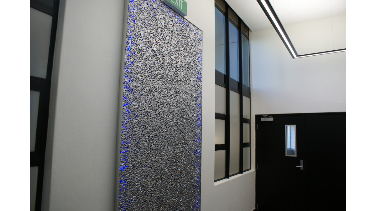 Alusion small cell, open on both sides as wall-mounted acoustic panels in the entrance foyer and stairwells of Bryce Street, Hamilton.