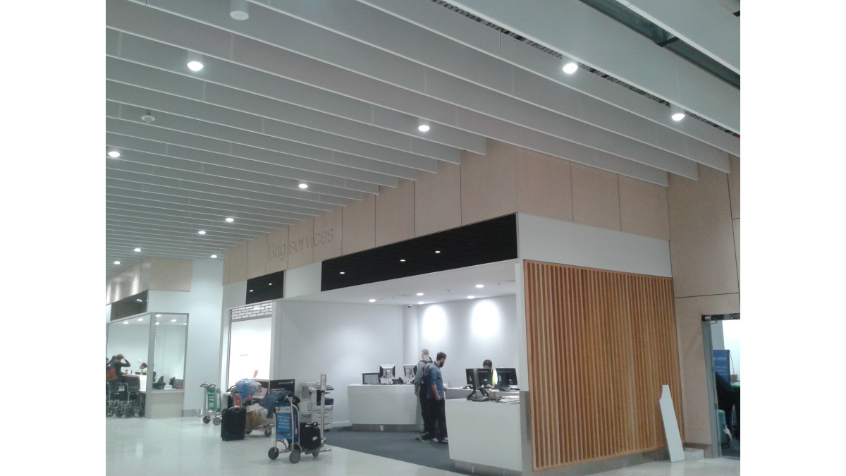 Armstrong Perforated Acoustic Baffle Ceiling Solutions in the Auckland International Airport Baggage Claim Area.