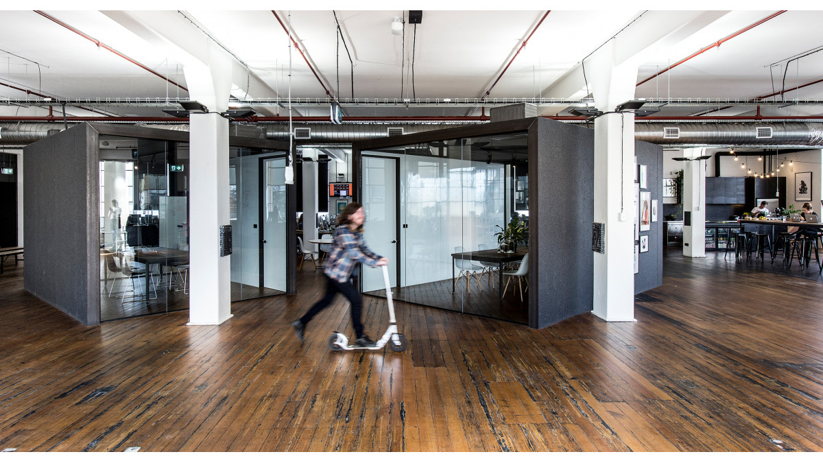 The Cube lined meeting pods create an interesting feature in 99 Designs open plan office.