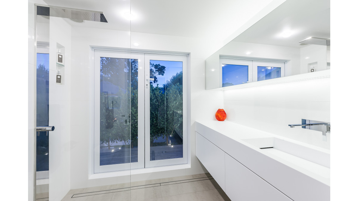 Vanity top, integrated sink and cabinet doors in Corian Architects White (now superseded by Corian Designer White). Design by Celia Visser. National Kitchen and Bathroom Association award-winning bathroom (2014).