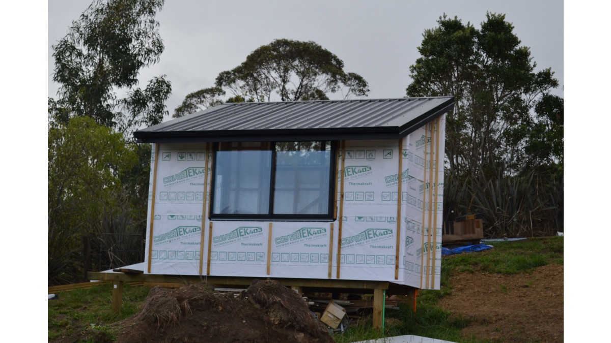 The office off to the side of the main house, featuring a Dimond Veedek roof.