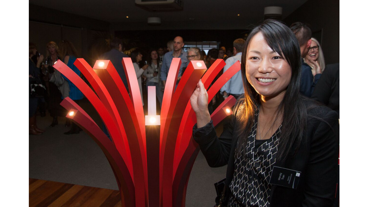 Wendy Tran's pohutukawa-inspired design combines art and function in dramatic Formica red and Formica Plex gold metallic laminate covered sprays of light.