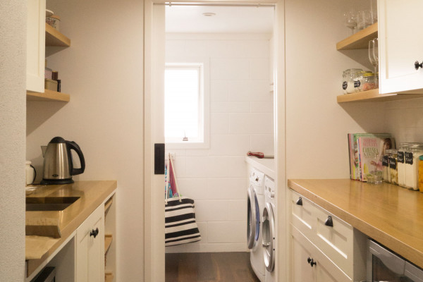 Self-closing Cavity Slider Divides Kitchen and Laundry Spaces