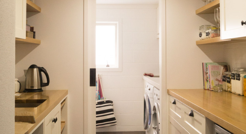 Self-closing Cavity Slider Divides Kitchen and Laundry Spaces