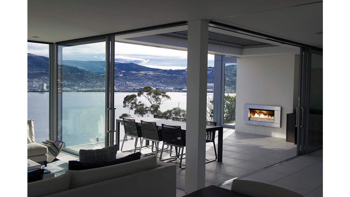 This Dunedin home makes the most of the stunning harbour views all year round with an Escea EF5000 underneath a retractable roof.  