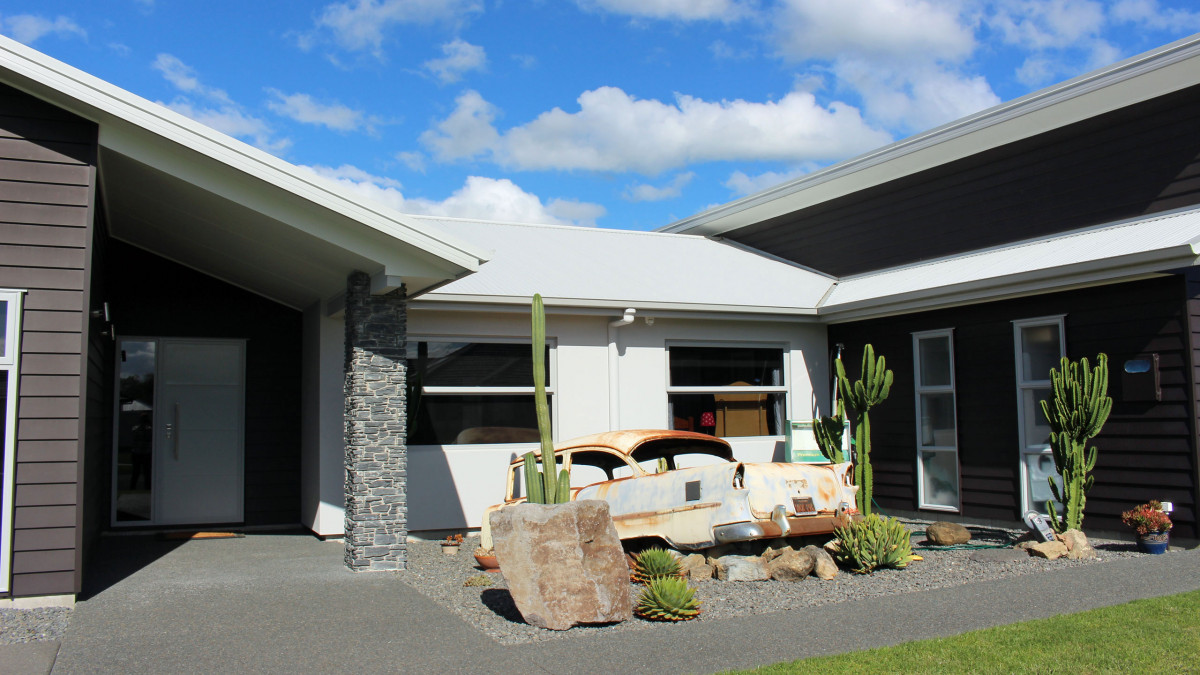 Contemporary home with desert scene in front garden.