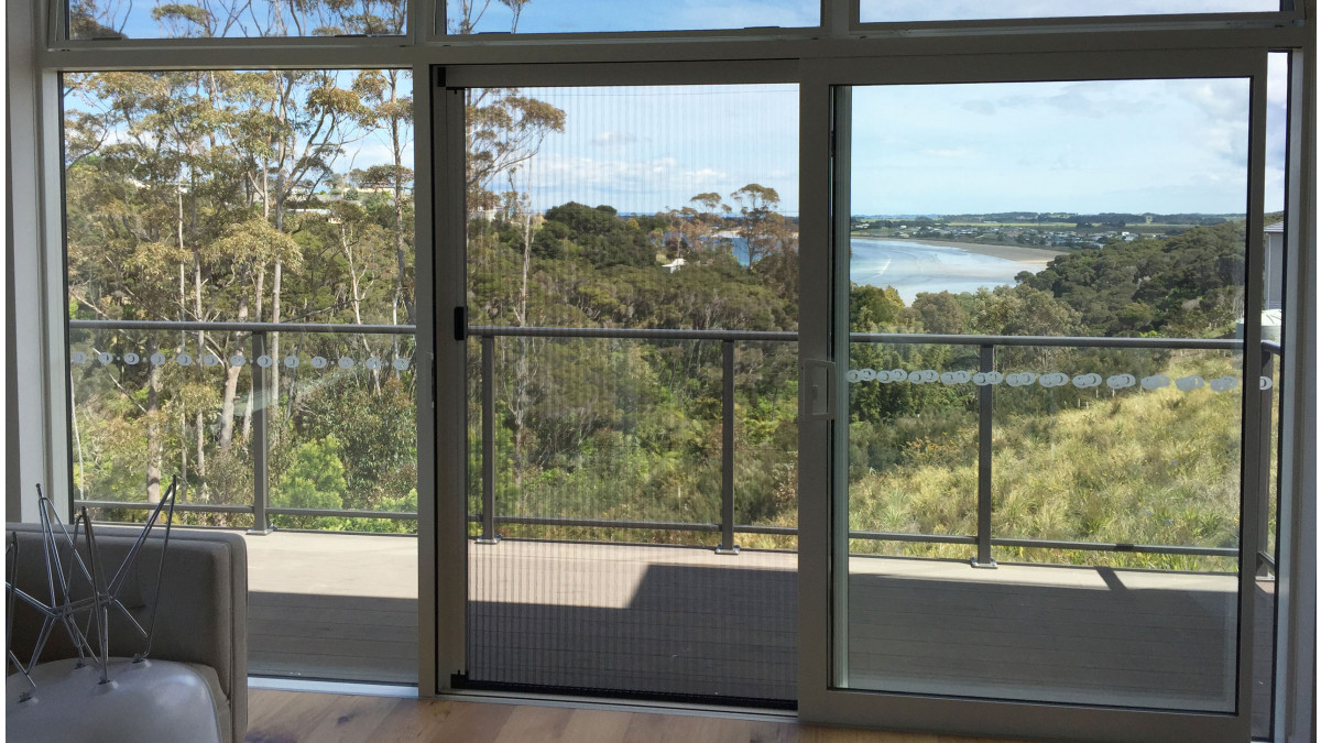 Venette Pleated Screens fitted onto balcony doors are semi-transparent for minimum impact on the beautiful view.