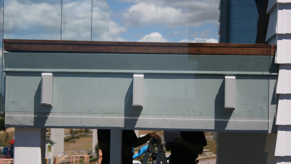 Problem: Deck edge details exposed through the glass panels.
