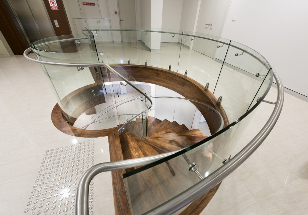 Glasshape Provides Dramatic Curved Glass Staircase for Atrium Homes