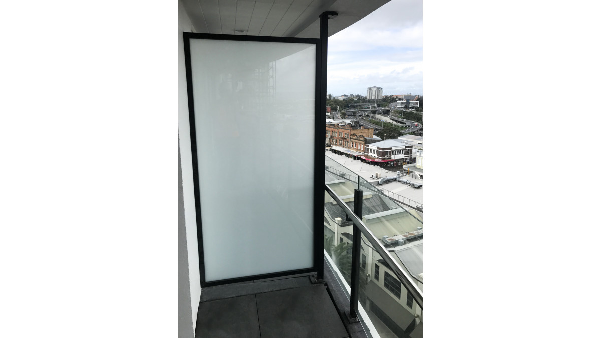 Frosted framed glass inter-tenancy screen.