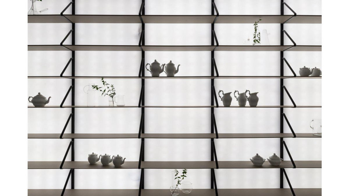 Fenix at Milan Design Week — black backlit shelves.