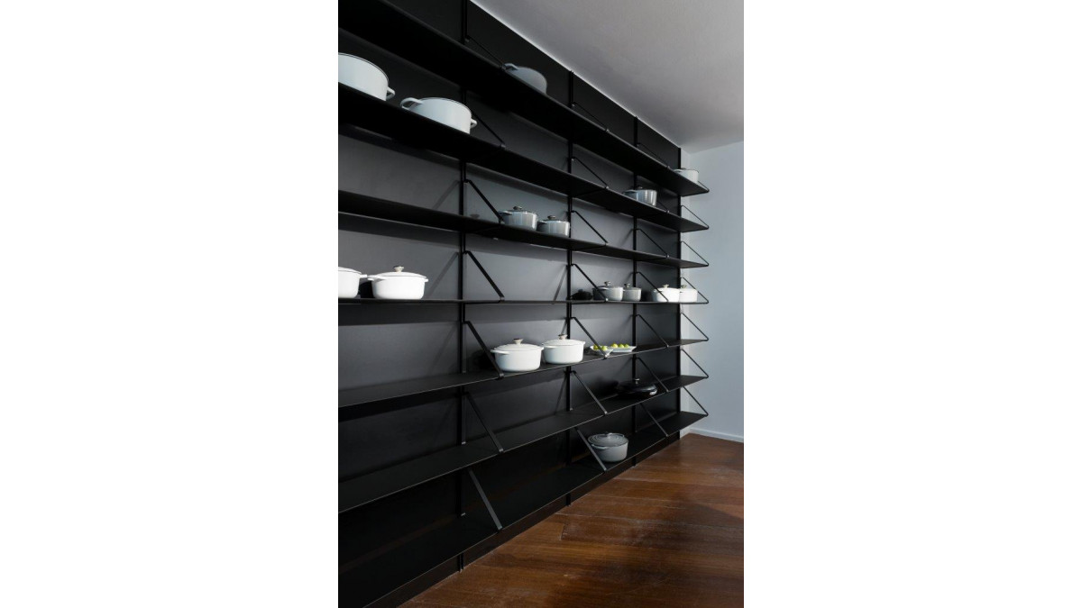 Fenix at Milan Design Week — black wall and shelves.