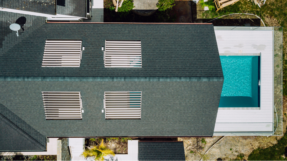 From above the four integrated louvre roofs in a stunning outdoor structure over the pool.