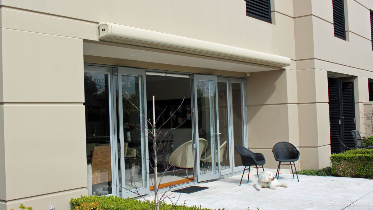 A Soleia Awning was the perfect solution for this apartment courtyard and blends in when it is being stored in its cassette box.