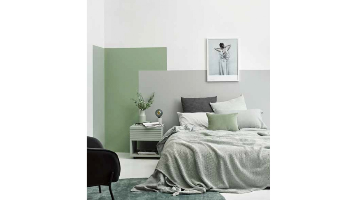 This bedroom is spilling over with similar shades of silvery sage. The expansive white walls and floors in Resene Alabaster have been grounded with a unique painted headboard feature in Resene Silver Chalice, Resene Peace and Resene Helix.