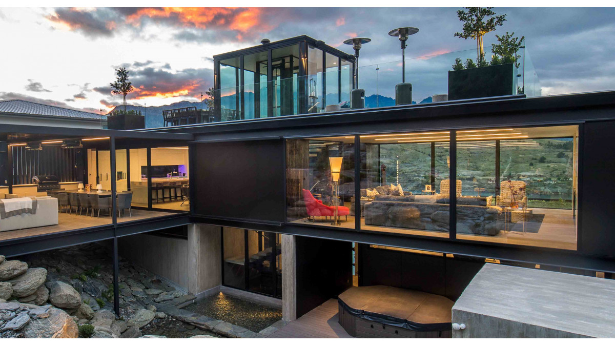 Clean roof-lines made possible with a Powerglide elevator. This centrepiece open-style elevator provides access over three floors in award-winning Queenstown home.
