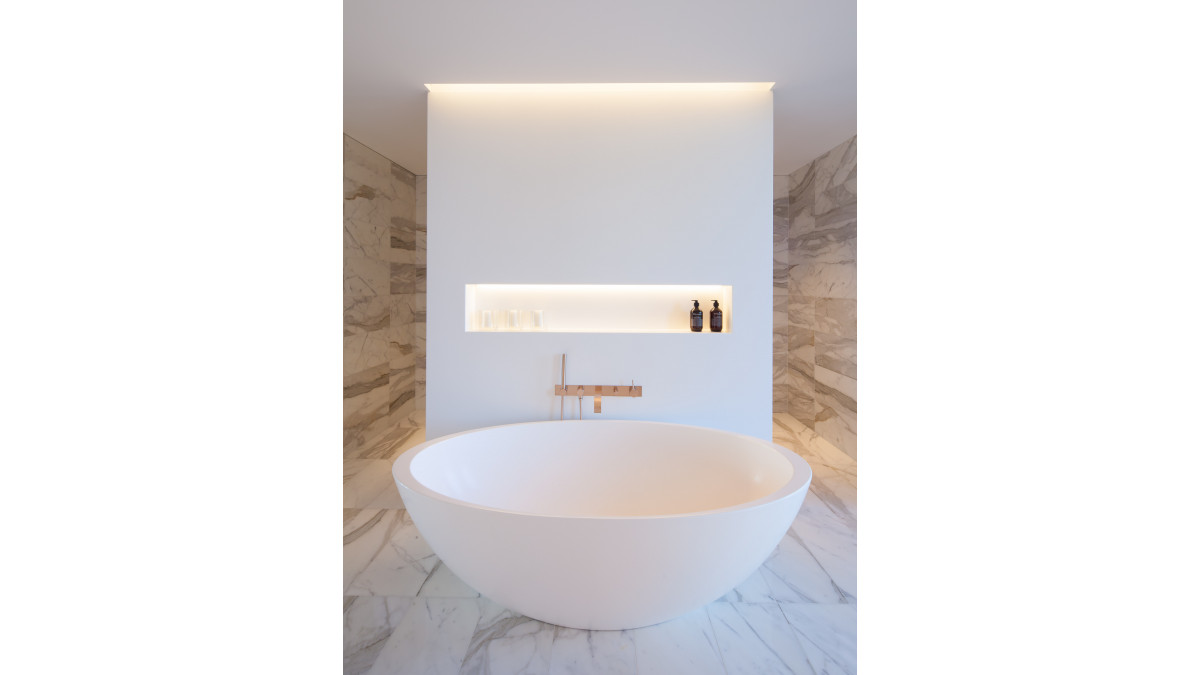 Corian wall in Glacier White with seamless inbuilt shelf. <br />
Photography: John Madden for Make Architects