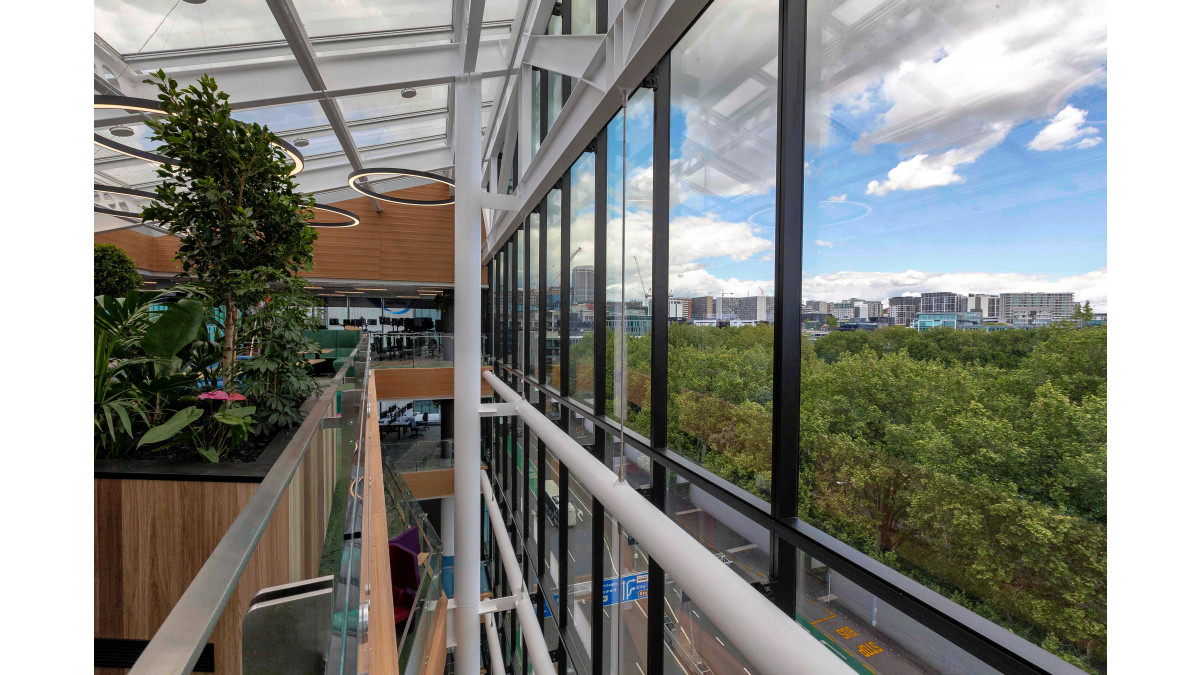 The atrium is placed on the building edge with an adjoining façade in APL 168mm Structural Glaze.