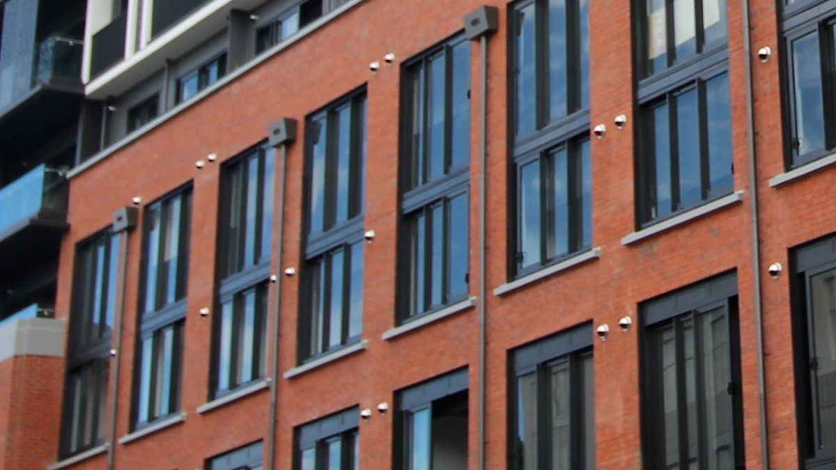 Brick veneer installed over Litecrete spandrels with windowsills visible.