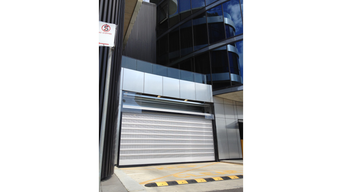 A soft chrome finish for the door closely matches chrome-coloured facade panels of the Mirage Building. 