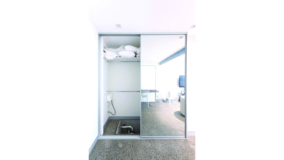 The Sanicubic 2 Pro WP system is discreetly positioned under flooring inside the closet.