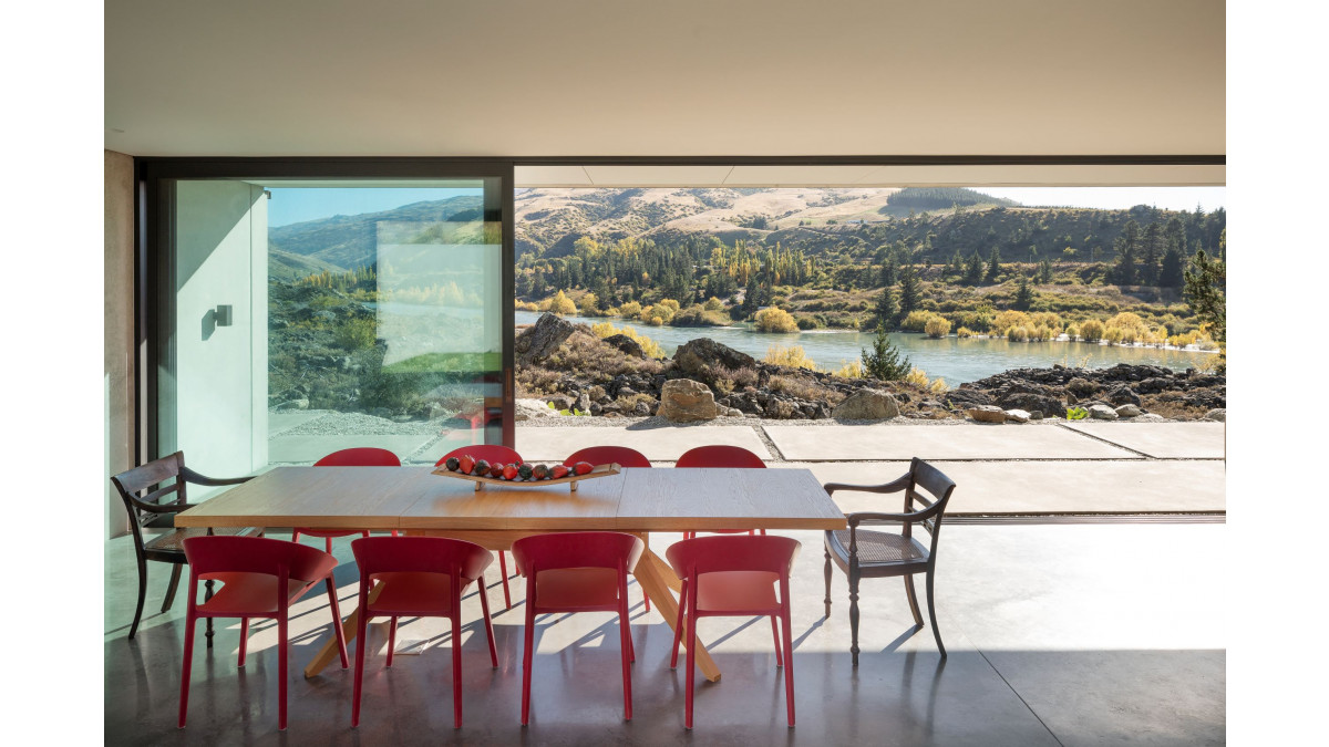 Floor-to-ceiling Altherm sliding doors powdercoated in Matt Flaxpod frames the view.