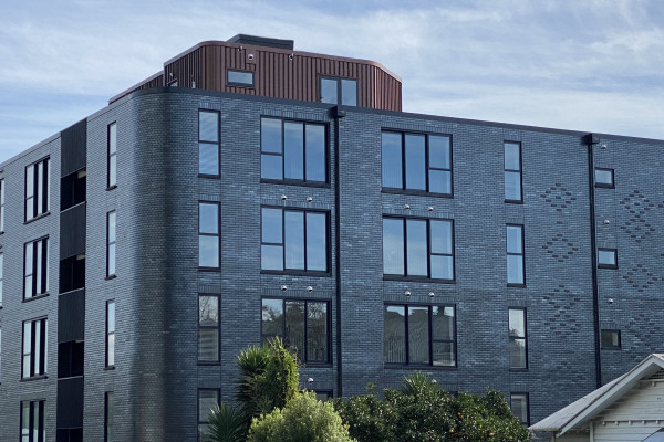 Modal Apartments Feature Standout Metallic Brick Facade
