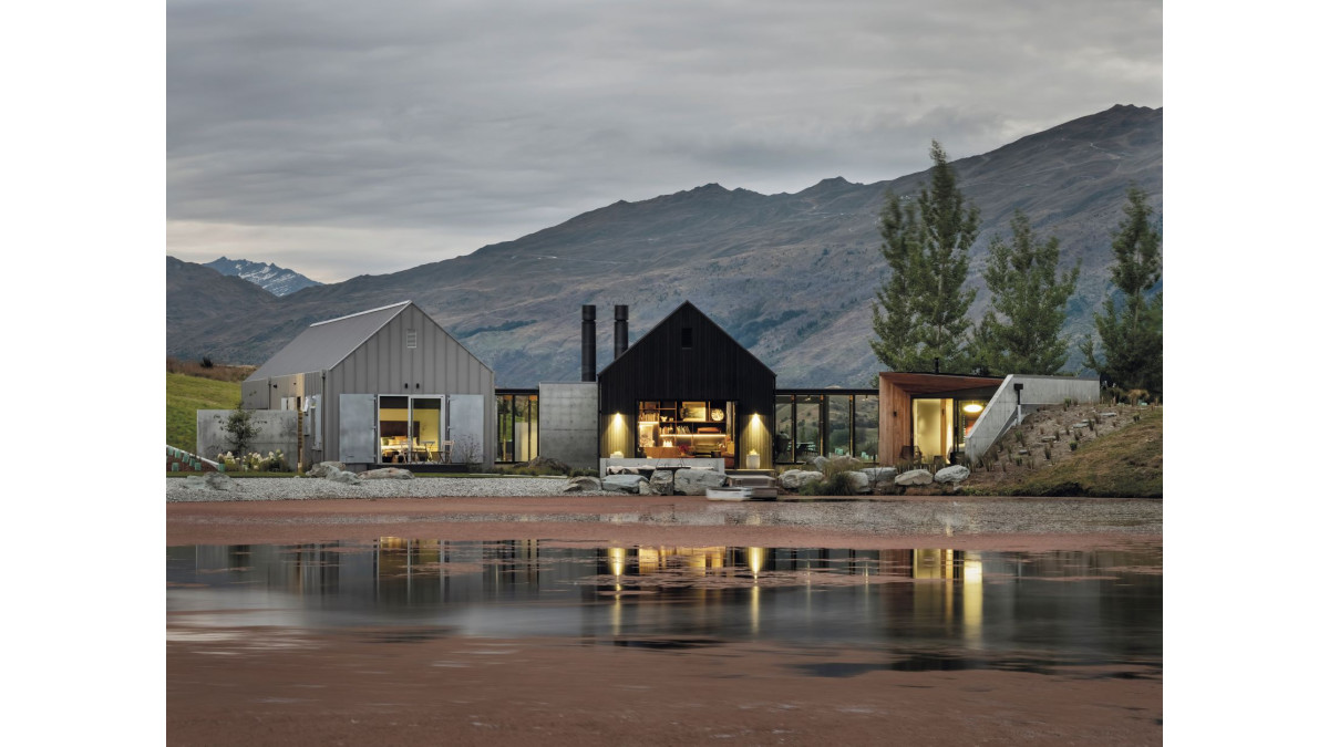 The property’s surrounding mountains and position on the edge of a pond informed how the home came together as three buildings.