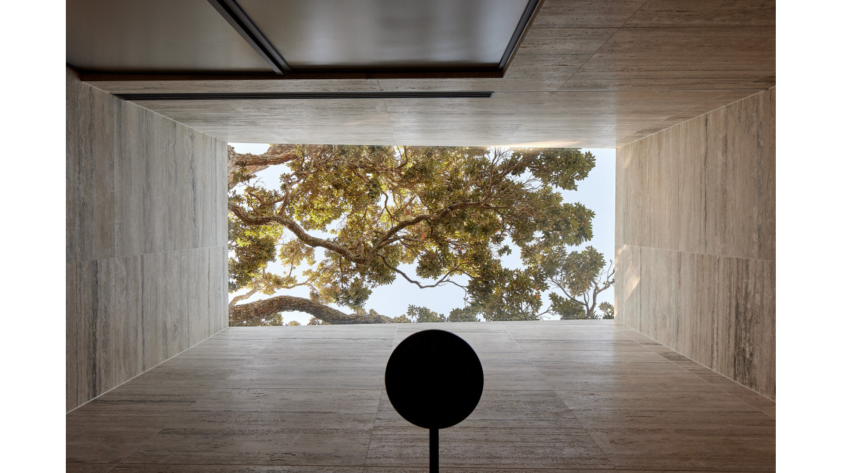 This ThermalHEART® roof window above the ensuite shower is thermally broken to retain heat. None of the joinery is showing, giving a clear view of the pōhutukawa above.