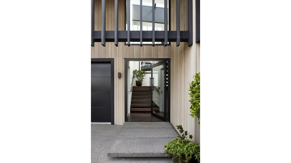 This Metro Series Hinged Door in Frost Ultra Black Anodised creates the perfect blend of indoor/outdoor flow.