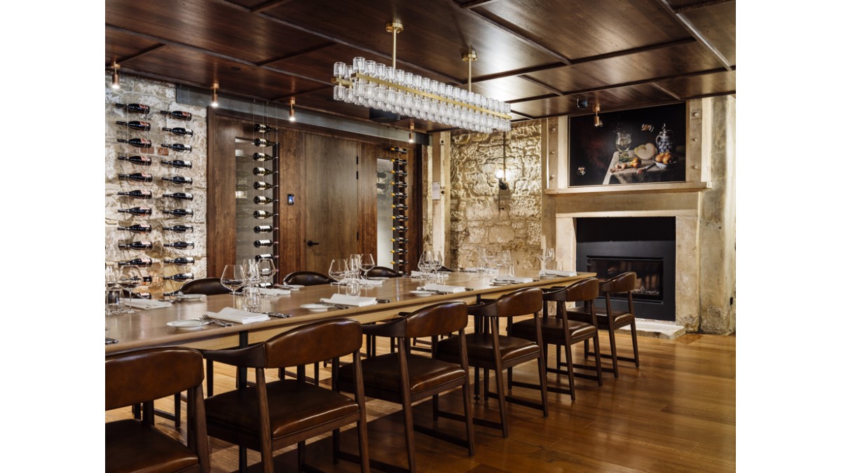 The Printing Room for private dining features sandstone walls, windows, and Escea’s DF960 Gas Fireplace.