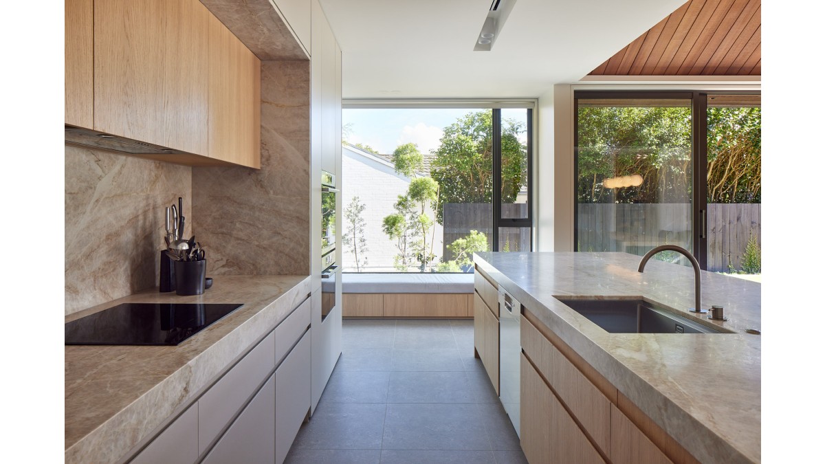 A window seat in the kitchen keeps the space inviting.