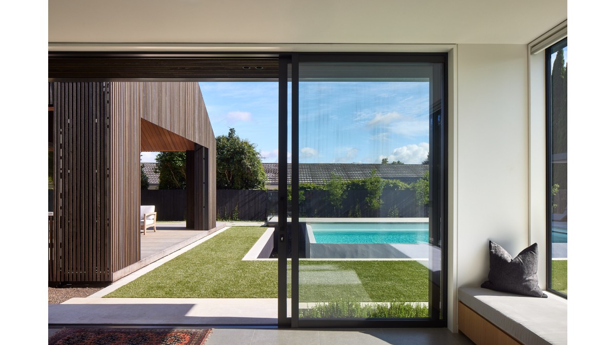 Sliding doors transition between the kids lounge and the pool.
