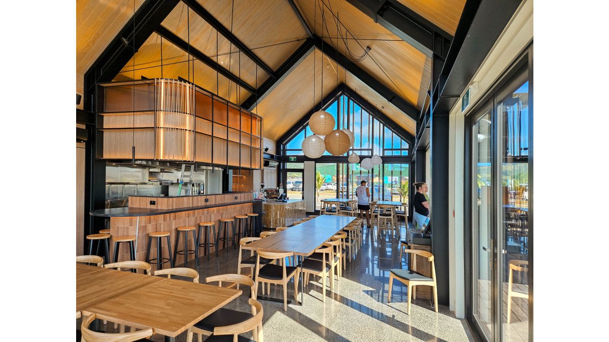 The café interior is ‘warmed up’ with a rough-sawn timber ceiling